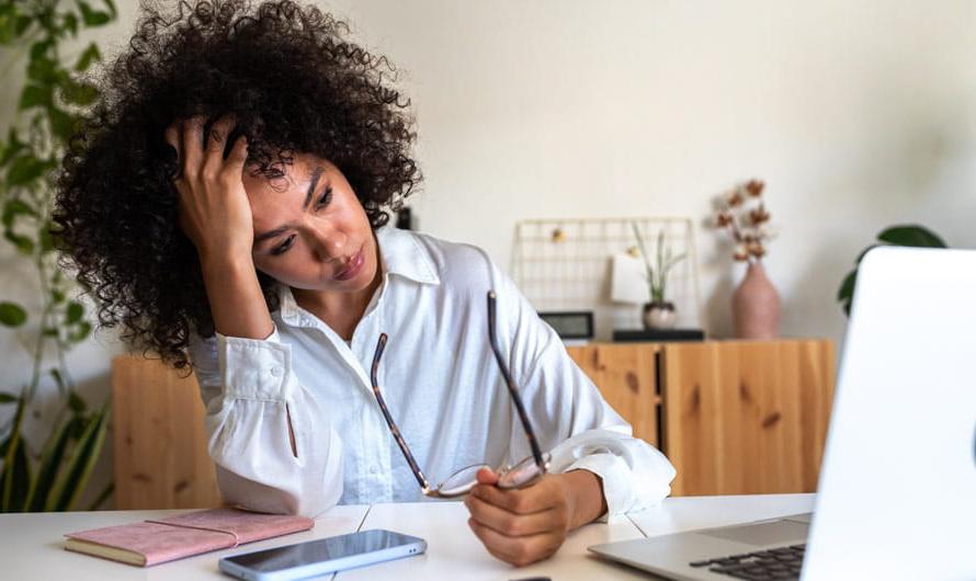 Women feeling stress sitting in front of her laptop.